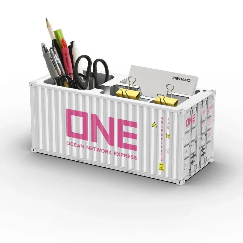 Organisateur bureau porte-stylo en forme de conteneur maritime blanc avec logo ONE rose et 3 compartiments visibles